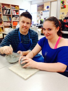 Teacher Zach Silverthorne gives Jacklyn Browne Camara a ceramics lesson.
