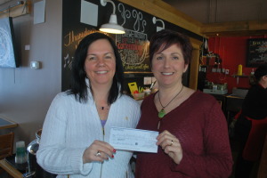 Laurie Didyk, right, owner of Station 1 Coffeehouse, presents GBF executive  director Stacy Elia with a cheque for $460 for the new meat program.